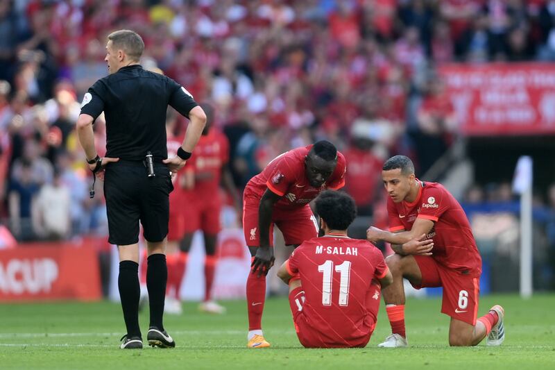 Liverpool's Mohamed Salah is consoled by Sadio Mane and Thiago Alcantara after going down with an injury. Getty