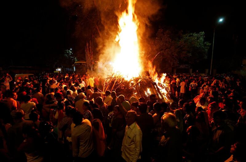 Hindu devotees walk around a bonfire during a ritual known as 'Holika Dahan' which is part of Holi festival celebrations in Ahmedabad. Amit Dave / Reuters