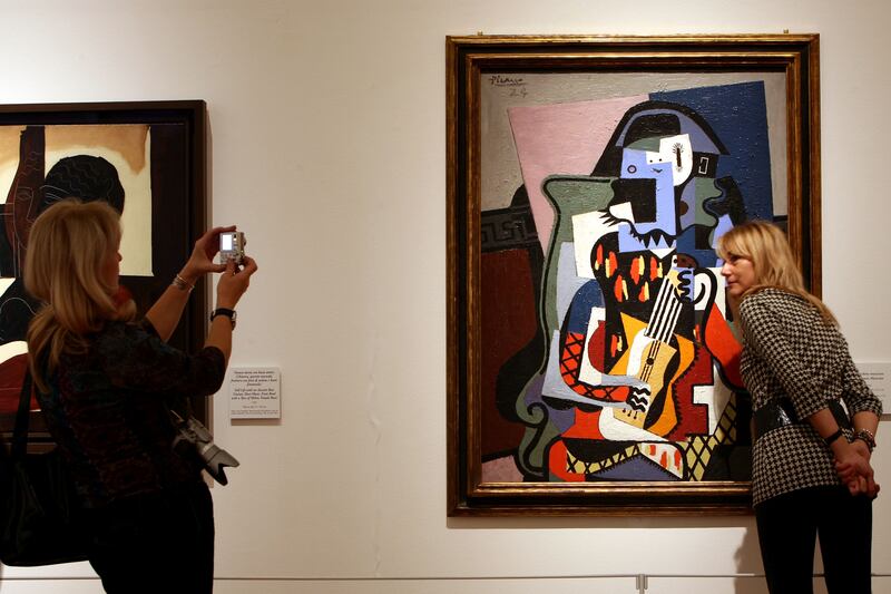 Harlequin the Musician by Picasso. Getty Images