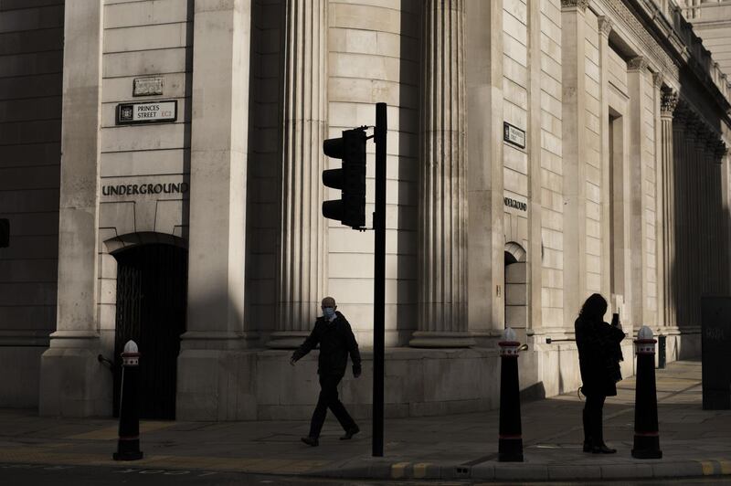 A pedestrian walks past the Bank of England (BOE) in the City of London, U.K., on Monday, Nov. 2, 2020. U.K. Prime Minister Boris Johnson, who on Saturday announced England will enter partial lockdown on Nov. 5, will on Monday try to fend off a looming rebellion from members of his Conservative Party by trying to reassure them the measures will only last four weeks. Photographer: Jason Alden/Bloomberg