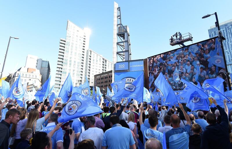 Fans await the start of Manchester City's open-top bus parade through Manchester, northern England on May 14, 2018 to celebrate winning the 2018 Premier League title.
Manchester City set the seal on a record-breaking season by becoming the first side in English top flight history to hit 100 points with victory at Southampton on Sunday. City also added another landmark by winning the league by a record 19 points from local rivals Manchester United.
 / AFP PHOTO / PAUL ELLIS