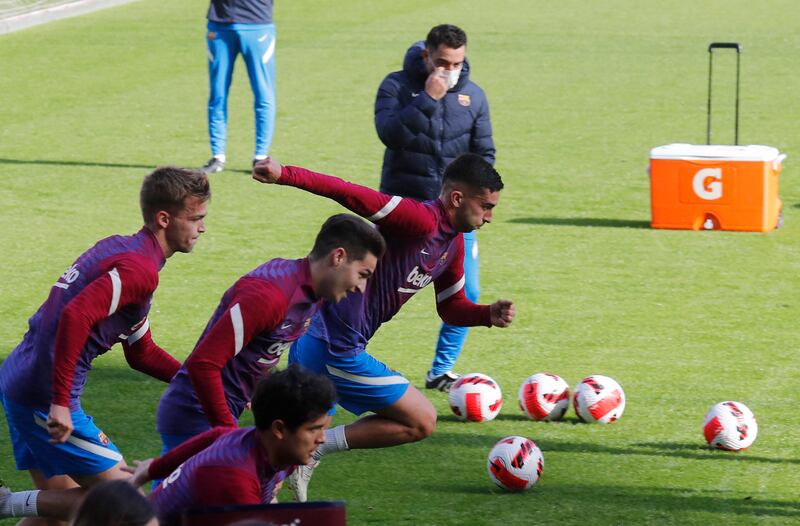 Barcelona manager Xavi with Ferran Torres during training. Reuters
