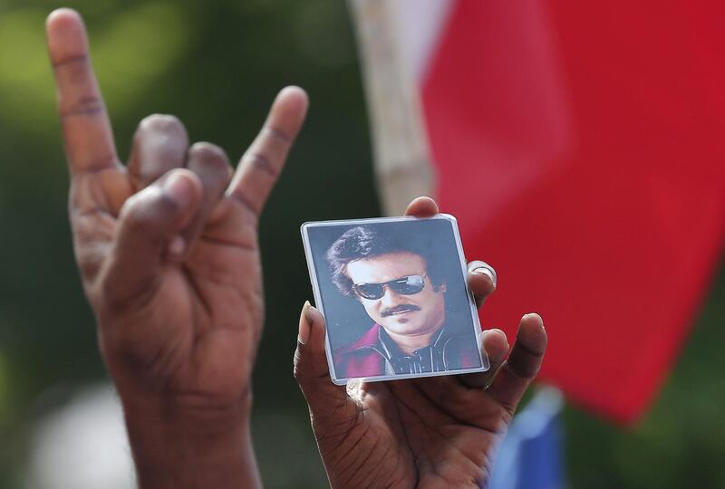 A picture of actor Rajinikanth is shown by a supporter as they celebrate the launch of his political party in Chennai, India. P Ravikumar / Reuters
