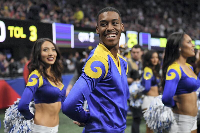 Rams cheerleader Quinton Peron smiles during Super Bowl LIII between the New England Patriots and the Los Angeles Rams at Mercedes-Benz Stadium in Atlanta, Georgia, on February 3, 2019. (Photo by TIMOTHY A. CLARY / AFP)