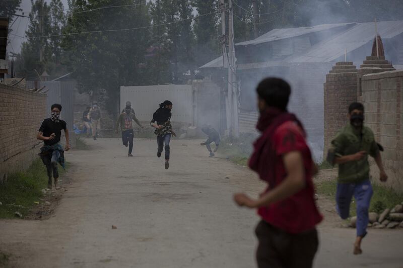 Kashmiri villagers run for cover. AP