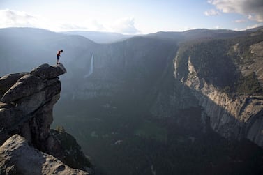 Alex Honnold peers over the edge of Glacier Point in Yosemite National Park after climbing 2000 feet up from the valley floor. National Geographic / Jimmy Chin.
