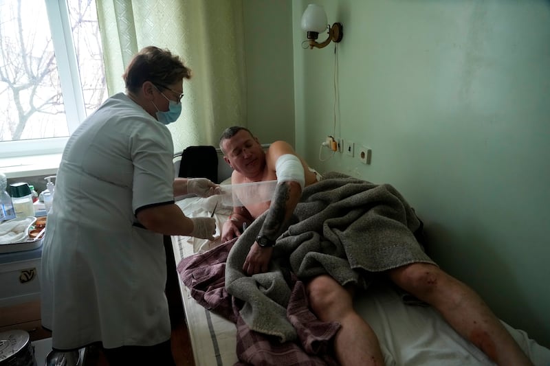 A medical worker attends to wounded man at a hospital in Brovary, outside Kiev. AP