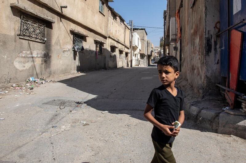 A young refugee looks on as he walks in a street at the Baqa'a Palestinian refugee urban camp, near Amman.  EPA
