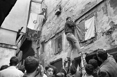 Young Algerians hang a national flag on a wall in the Casbah of Algiers on July 6, 1962,  a day after the proclamation of the independence. AFP