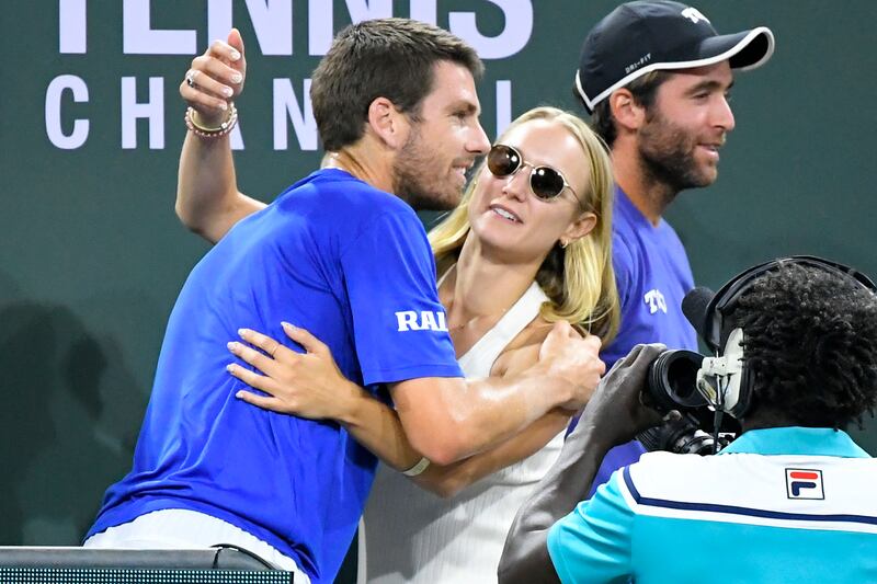 Cameron Norrie, left, of Britain, gets a hug from Louise Jacobi after he defeated Nikoloz Basilashvili, of Georgia. AP Photo