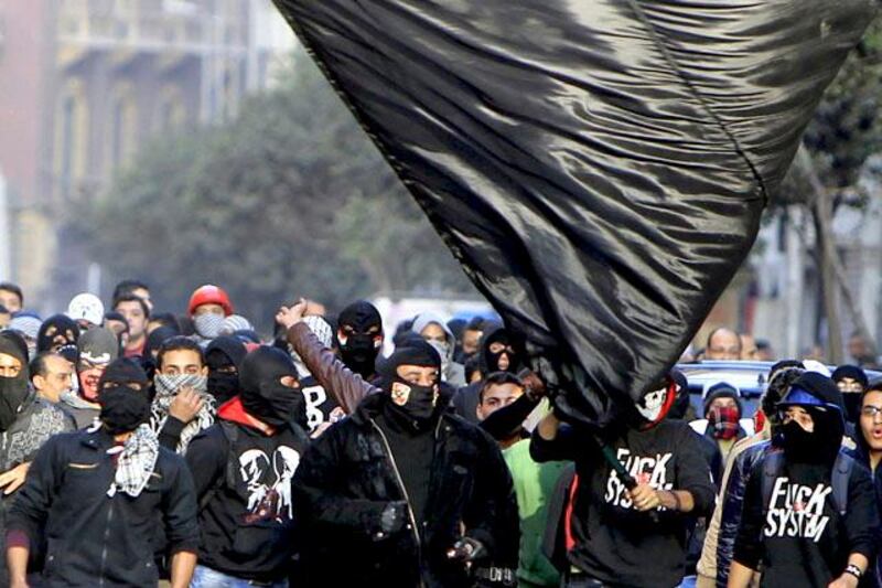 Members of the Black Bloc are seen during the protest in Tahrir Square in Cairo January 25, 2013. Egypt marks the second anniversary of the uprising that swept Hosni Mubarak from power with little to celebrate. Deeply divided and facing an economic crisis, the nation is bracing for more protests, but this time against a freely elected leader. REUTERS/Mohamed Abd El Ghany  (EGYPT - Tags: POLITICS CIVIL UNREST)