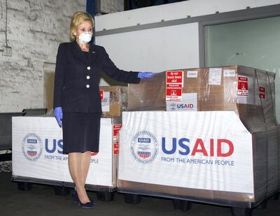 In this photo taken Monday May 11, 2020 at OR Tambo Airport Johannesurg and supplied by the United States Embassy in Pretoria, South Africa, showing U.S. Ambassador to South Africa Lana Marks posing with ventilators donated by the U.S. Government. The United State is donating up to 1000 ventilators to assist with South Africa's national response to COVID-19. (Photo/Leon Kgoedi, United States Embassy South Africa via AP)