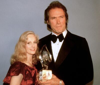 FILE - In this March 5, 1981 file photo, Clint Eastwood poses with his girlfriend Sondra Locke, left, and his People's Choice Award for favorite motion picture actor in Los Angeles. A death certificate obtained by The Associated Press shows Oscar-nominated actress Locke died Nov. 3, 2018, at age 74 at her home in Los Angeles of cardiac arrest stemming from breast and bone cancer. Locke was best known for the six films she made with Eastwood in the late 1970s and early 1980s, including "The Outlaw Josey Wales," ''Every Which Way But Loose," and "Sudden Impact." (AP Photo, File)