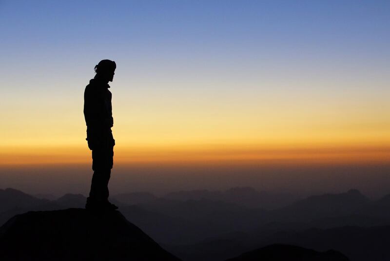 A tourist watches the sun rise outside a church on the top of Mount Sinai. EPA