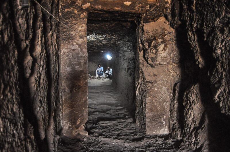 Egyptian archaeologists work inside a newly-discovered tomb of Shedsu-Djehuty at the Draa Abul Naga necropolis in Luxor's West Bank, 700km south of Cairo.  AFP