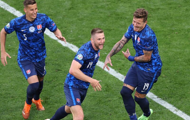 Slovakia's Milan Skriniar, centre, celebrates after scoring his side's second goal during the Euro 2020 soccer championship group E match between Poland and Slovakia at Gazprom arena stadium in St. Petersburg, Russia, Monday, June 14, 2021. (Anton Vaganov/Pool via AP)