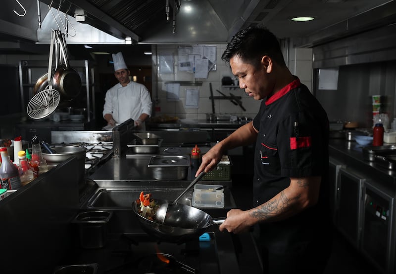 Head chef Keng fries up ingredients for the vegan pad Thai with rice noodles, mixed veg and tofu in a homemade sweet tamarind sauce at Cafe Isan in JLT, Dubai
