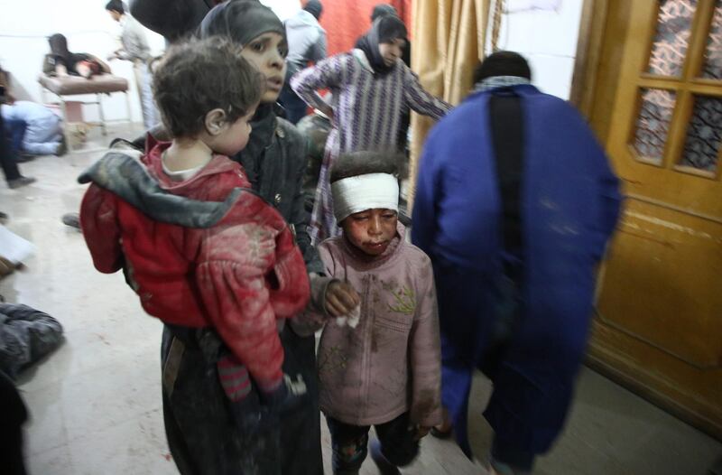 Wounded Syrians seek treatment at a make-shift hospital in Kafr Batna.  Amer Almohibany / AFP Photo