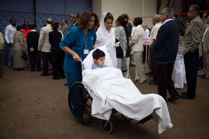 Alyaz Merali, an eight-year-old muslim boy who received two gunshot wounds during the attack by gunmen at the Westgate Shopping Centre, takes part in the funeral procession for his mother, Selima Merali  and sister Nuriana Merali, who were both killed in the attack. Uriel Sinai / Getty Images