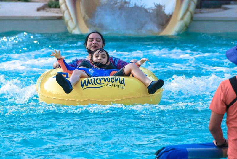Abu Dhabi, United Arab Emirates, August 4, 2020.   Yas Waterworld Abu Dhabi opens with 30% capacity as Covid-19 restrictions slowly come to an ease.  A mother and her son come out of one of the giant slides at the waterpark.
Victor Besa /The National
Section: NA
Reporter: