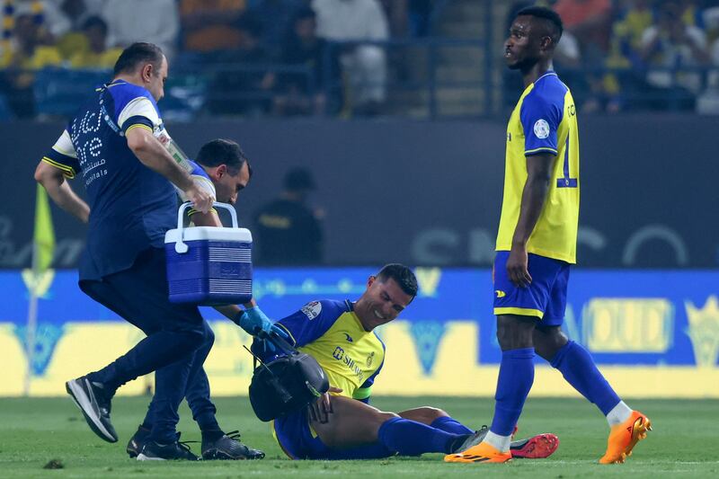 Al Nassr forward Cristiano Ronaldo receives medical attention on the pitch. AFP