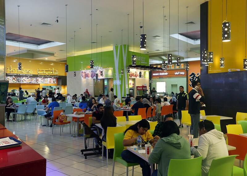 Shoppers dine at the food court at Ibn Battuta Mall in Dubai. Satish Kumar / The National