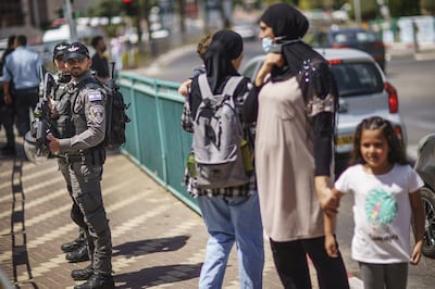 Police stand by during a demonstration calling for justice in the killing of Musa Hassuna in the mixed Arab-Jewish town of Lod, central Israel, Friday, May 28, 2021. Two Lod residents were killed in the recent clashes, Hassuna, 32, by a suspected Jewish gunman and Yigal Yehoshua, 56, by suspected Arab attackers. No charges have been filed in either case, and police say investigations are ongoing. (AP Photo/David Goldman)