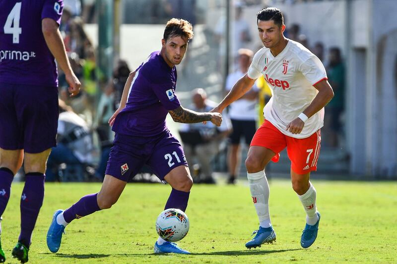 Fiorentina's Spanish defender Pol Lirola and Juventus' Portuguese forward Cristiano Ronaldo go for the ball. AFP