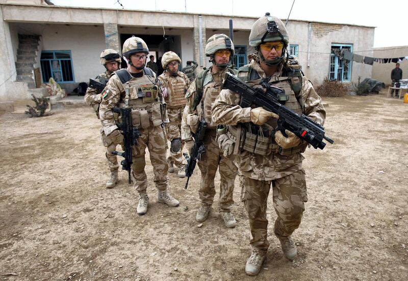 British soldier Lieutenant-Colonel Nick Lock (2L) gathers his soldiers of the 1st Batallion of the Royal Welsh before a patrol in the streets of Showal in Nad-e-Ali district, Southern Afghanistan, in Helmand Province on February 25, 2010. Combined forces of 15,000 US, NATO and Afghan troops are facing stiff resistance in pockets of Helmand province where they are battling to eradicate Taliban fighters who have controlled the area with drug lords for years.  AFP PHOTO/Thomas COEX (Photo by THOMAS COEX / AFP)