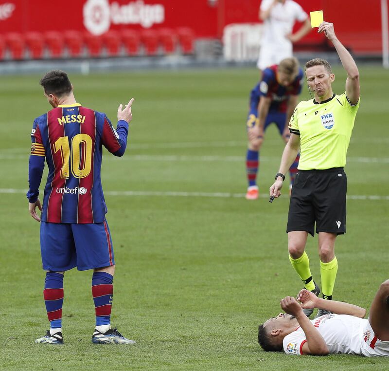 Barcelona's Lionel Messi is shown a yellow card by referee Alejandro Hernandez Hernandez. EPA