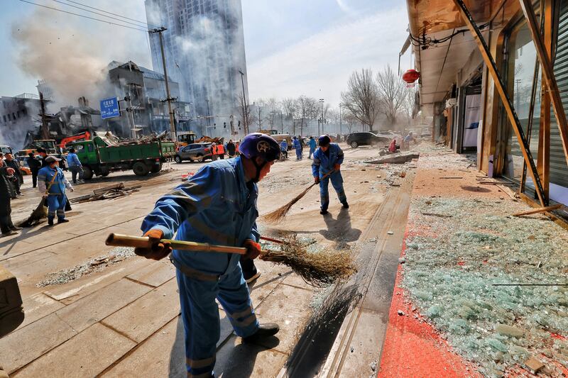 Workers clean up debris after a restaurant explosion in Sanhe, Hebei province, China. Reuters