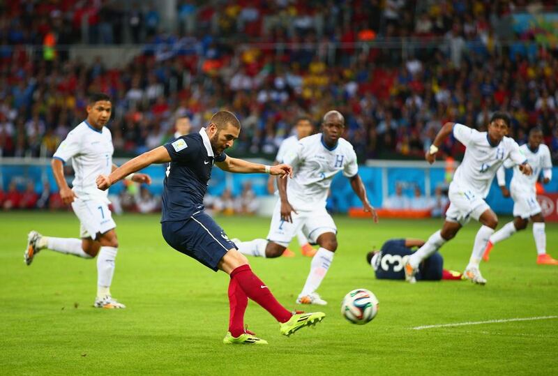 Karim Benzema of France shoots and scores his team's third goal, his second, during their match against Honduras on Sunday at the 2014 World Cup in Porto Alegre, Brazil. Paul Gilham / Getty Images