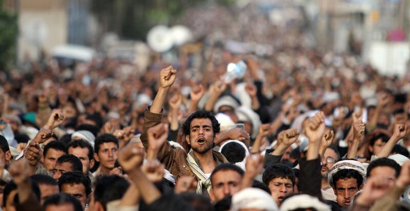 Supporters of Houthi shouted slogans during a march to demand the government to dissolve foreign intelligence service in Sanaa.  Mohamed al-Sayaghi / Reuters