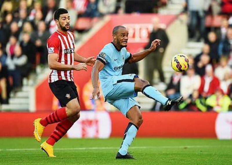 Vincent Kompany, right, of Manchester City clears the ball from Graziano Pelle of Southampton during their Premier League match at St Mary's Stadium on November 30, 2014 in Southampton, England. (Photo by Shaun Botterill/Getty Images)