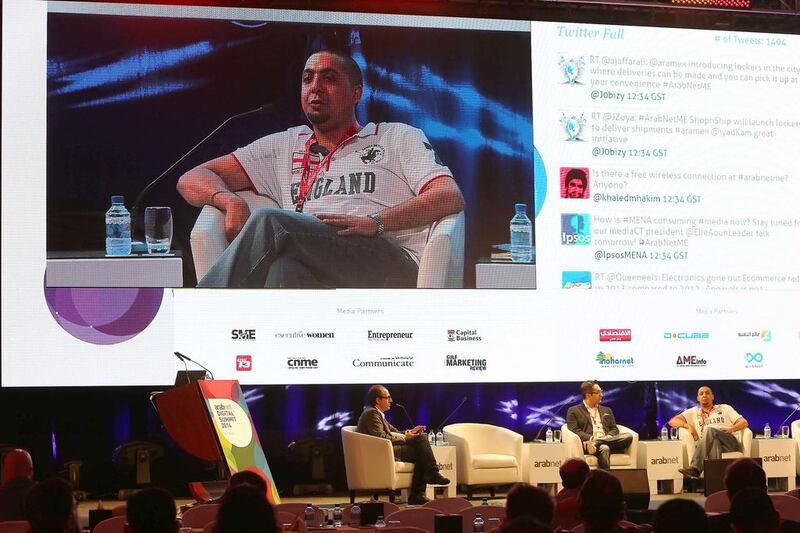 Sajjad Bhojani of eXtra, on the screen, speaks at the ArabNet Digital Summit 2014 panel discussion on e-retail and e-supermarkets. Pawan Singh / The National