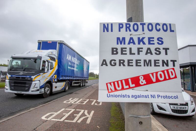 A lorry passes a sign bearing a message opposing the Northern Ireland Protocol near the port of Larne. AFP