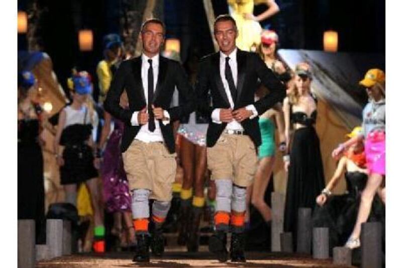 The designers Dan, left, and Dean Caten acknowledge the audience at the end of DSquared spring/summer 2010 ready-to-wear show last September during fashion week in Milan. Christophe Simon / AFP Photo