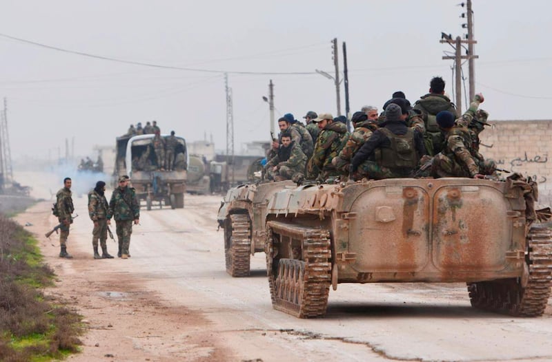 In this photo released Wednesday Feb. 5, 2020 by the Syrian official news agency SANA, shows Syrian government forces entering the village of Tel-Toukan, in Idlib province, northwest Syria. On Thursday, State media and opposition activists said Turkey has sent more reinforcements into northwestern Syria, setting up new positions in an attempt to stop a government offensive on the last rebel stronghold in the war-torn country. (SANA via AP)