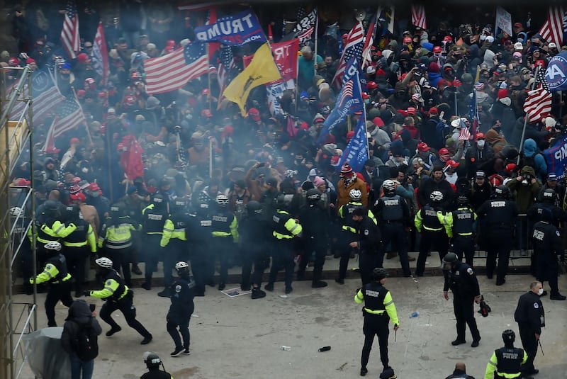 Police hold back supporters of US President Donald Trump as they gather outside the US Capitol's Rotunda. AFP