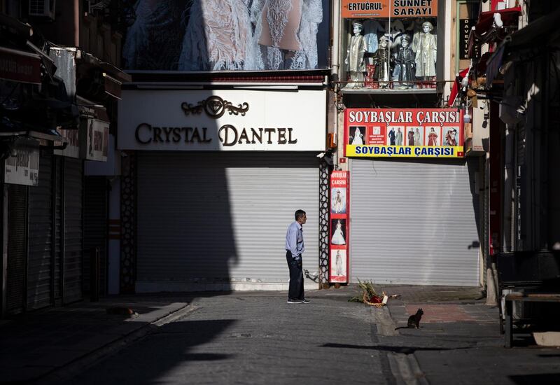 A man stands in front of the closed shops at Istanbul's old bazaar Tahtakale during curfew in Istanbul. EPA