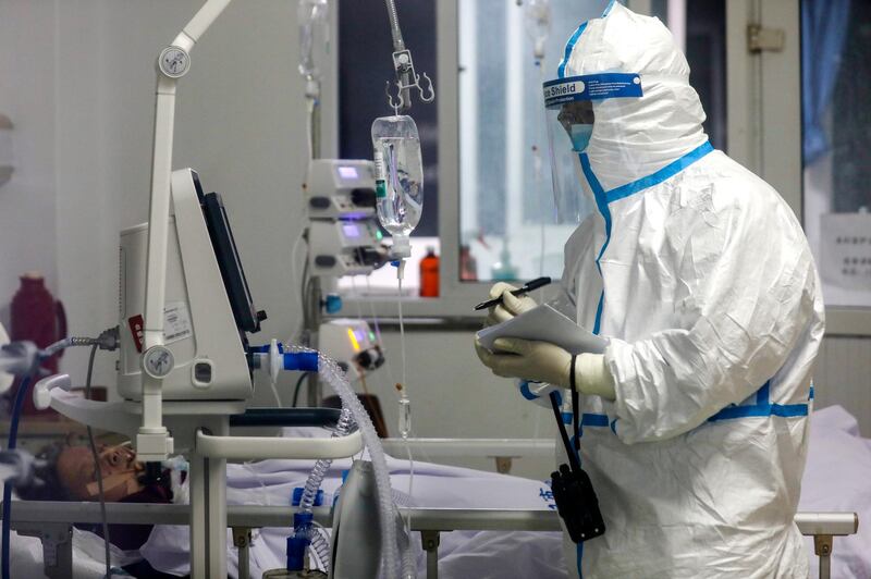 A medical worker records down a patient's condition at Jinyintan Hospital designated for new coronavirus infected patients, in Wuhan in central China's Hubei province.  AP