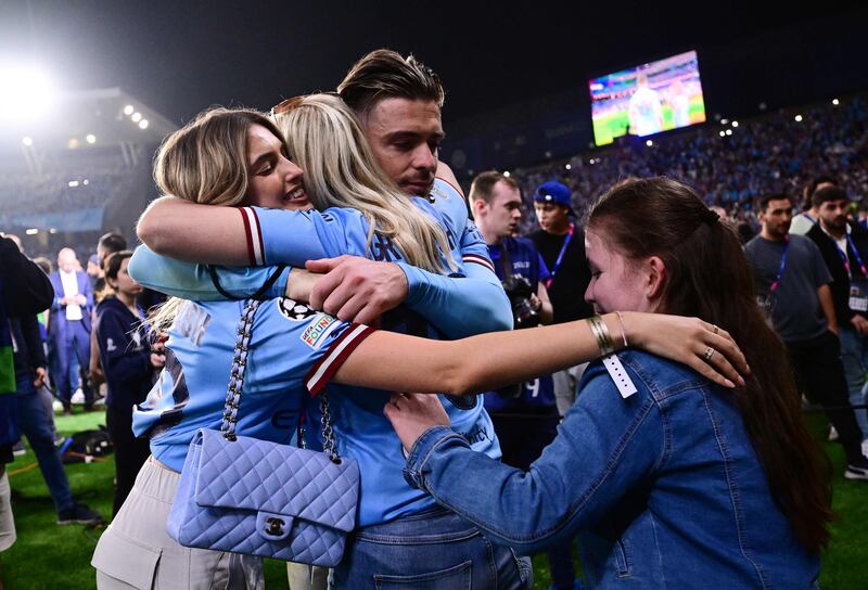 Manchester City's English midfielder #10 Jack Grealish celebrates with his girlfriend and relatives after winning the UEFA Champions League final football match between Inter Milan and Manchester City. AFP