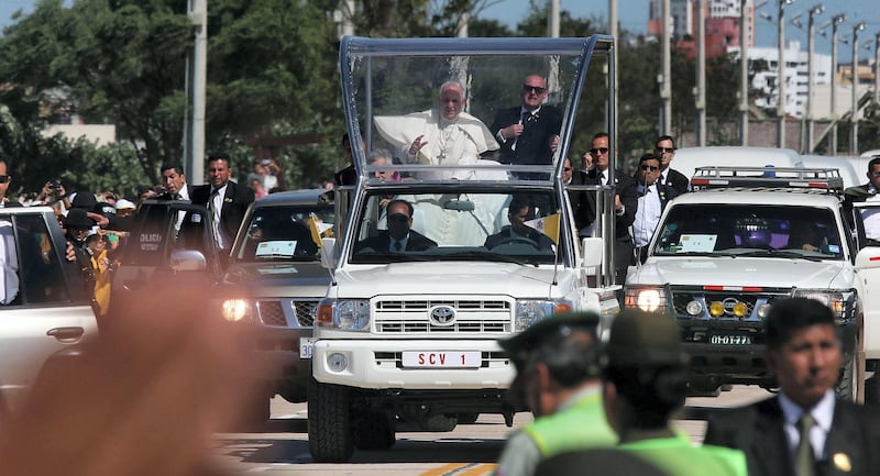 SANTA CRUZ, BOLIVIA - JULY 10:  Pope Francis (C) waves from the Popemobile on his way to the airport on July 10, 2015 in Santa Cruz, Bolivia. The Pope visited one of Bolivia's most notorious prisons earlier in the day. Pope Francis is now heading to Paraguay for the final leg of his three-country South American visit. The Pope held an open-air Mass in Santa Cruz yesterday.  (Photo by Mario Tama/Getty Images)