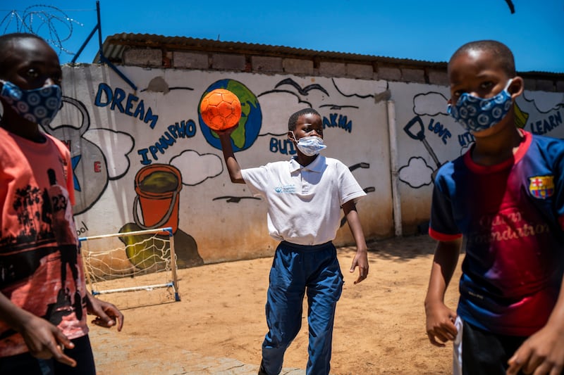 Pupils wear their masks in the playground at Kgololo Academy. AP