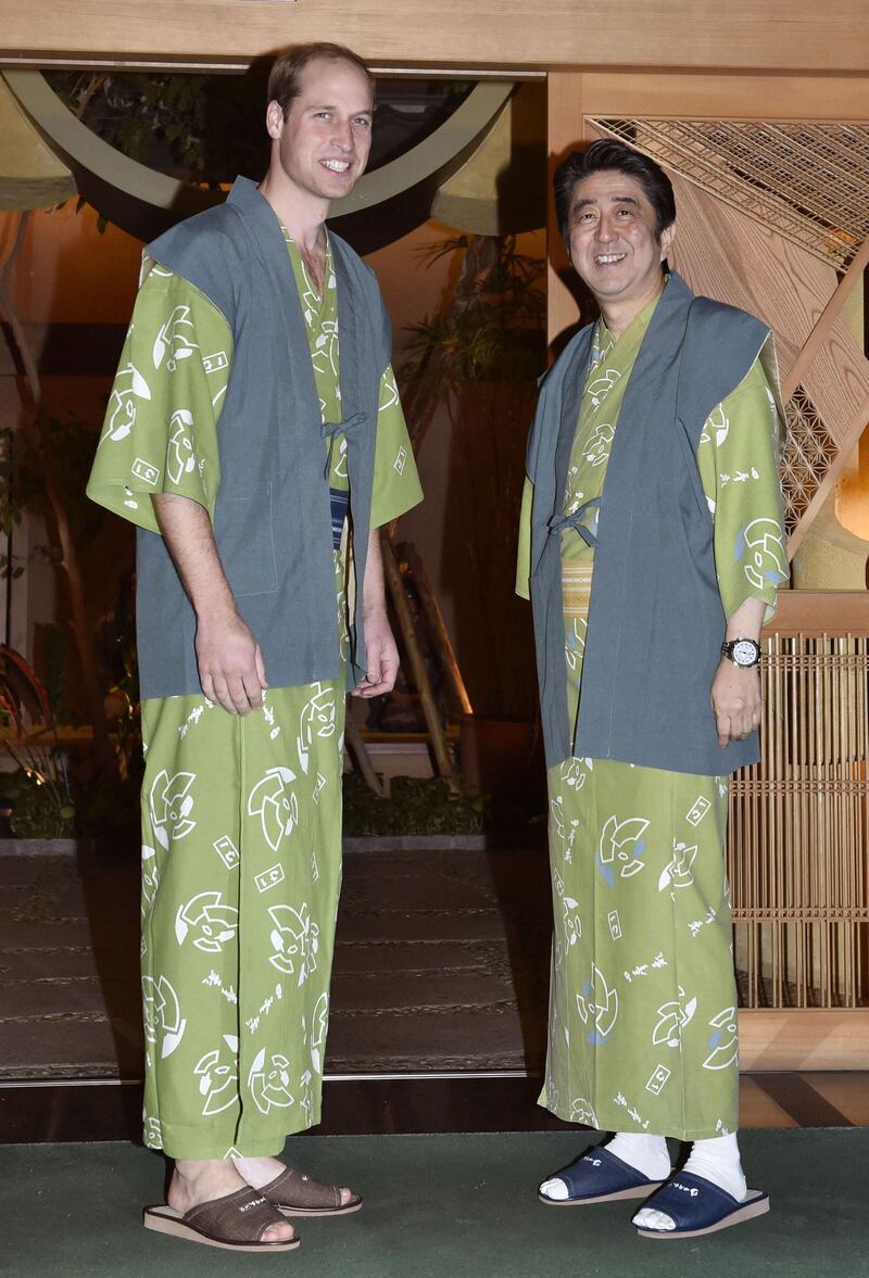 Britain’s Prince William (L) and Shinzo Abe wearing "yukatas", or kimono-style cotton outfits as they pose together before a dinner in Koriyama in Fukushima prefecture on February 28, 2015. AFP