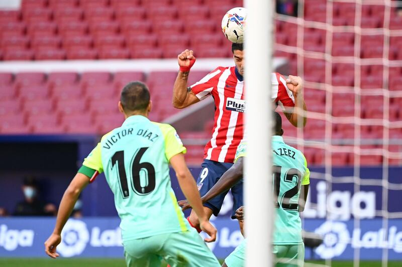 Luis Suarez scores with a header for Atletico against Granada. AFP