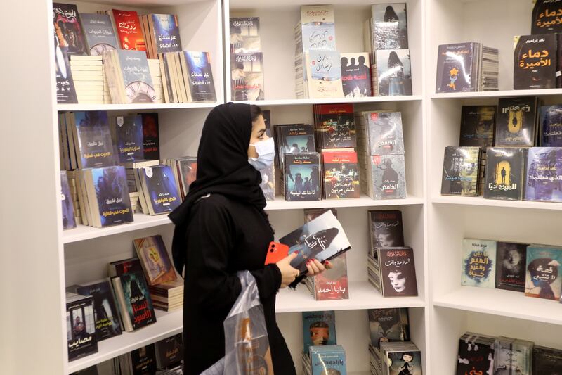 A woman looks for books in Riyadh.