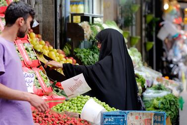 An Iranian woman shops in a store in a street in Tehran, Iran, 13 May 2022.  The Iranian government on 12 May increased the price of basic food items such as cooking oil, chicken, eggs and dairy products as much as 300 percent.   EPA / ABEDIN TAHERKENAREH