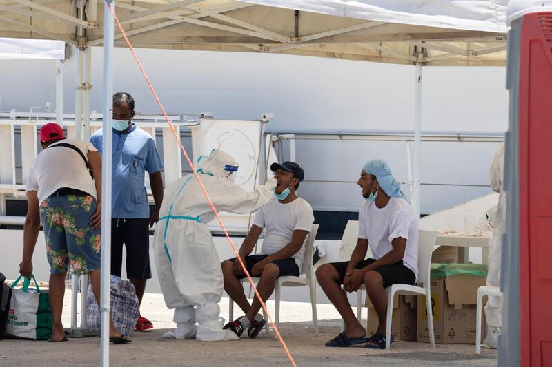 epa08576788 160 migrants, previously arrived in Lampedusa, on their arrival in Pozzallo, near Ragusa, Italy, 31 July 2020. Theyâ€™ve all been swabbed for Covid-19.  EPA/FRANCESCO RUTA
