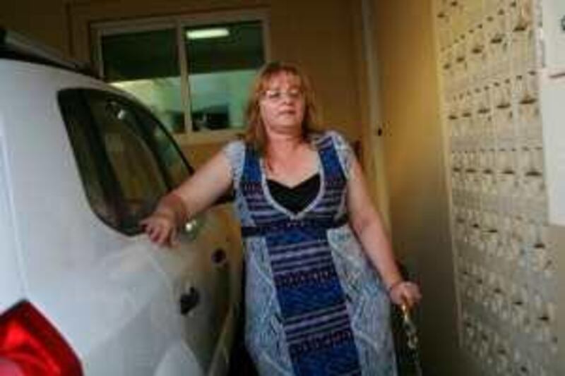 Abu Dhabi - September 18, 2009: Linda Arthur, 48, from Alberta, Canada, who suffers from chronic pain and would like the UAE to allow Codeine, takes a break while walking past her car at her home. ( Philip Cheung / The National ) 